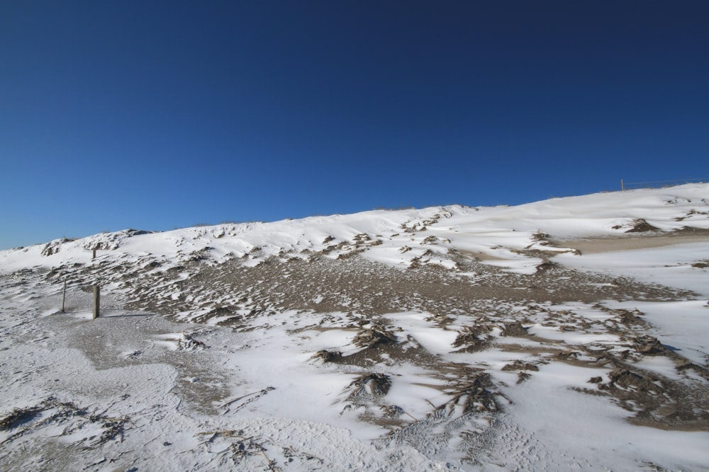 a snowy mountain with blue sky