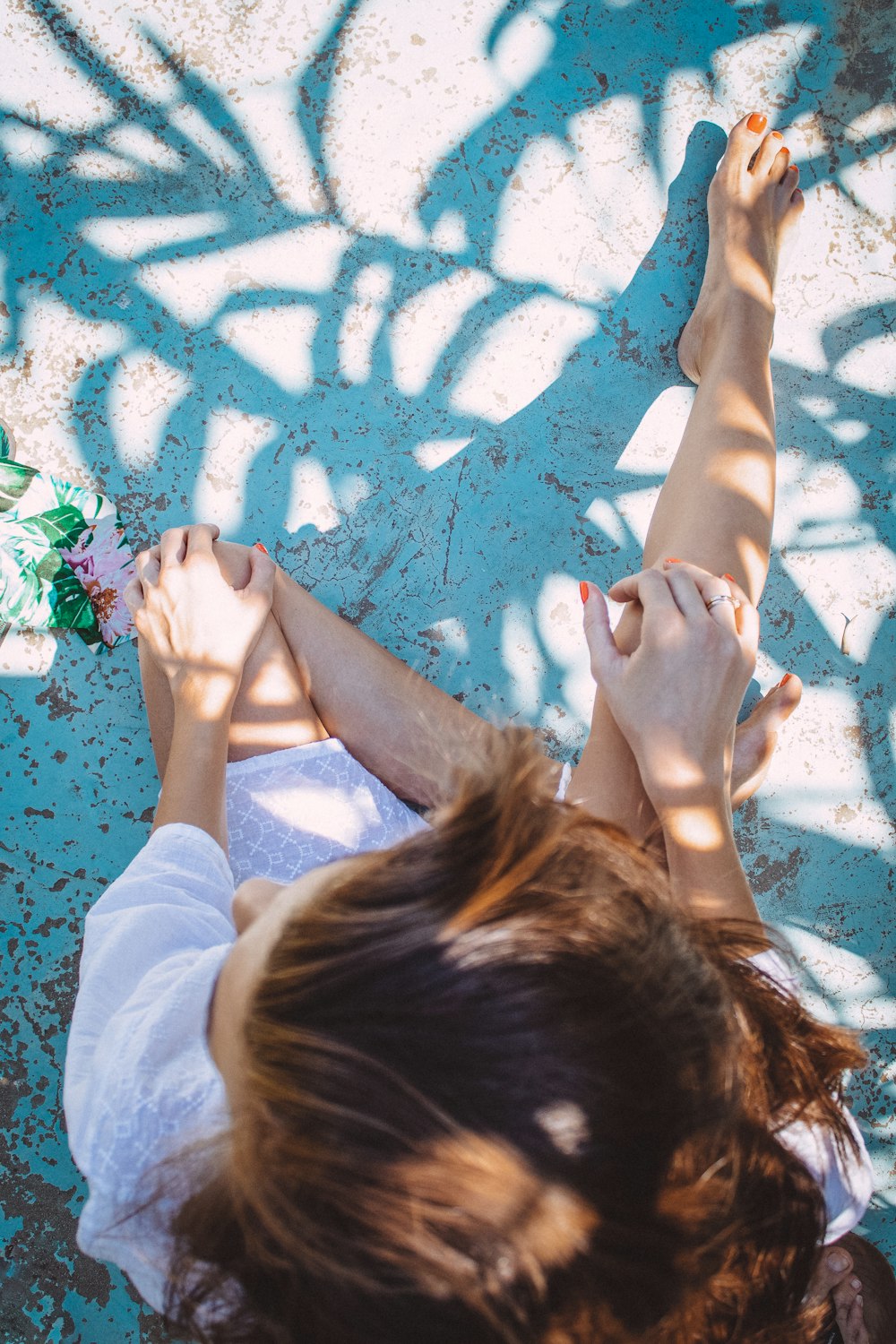 a person lying on a blue and white rug