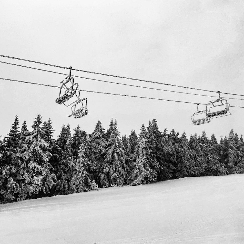 a ski lift going up a snowy hill