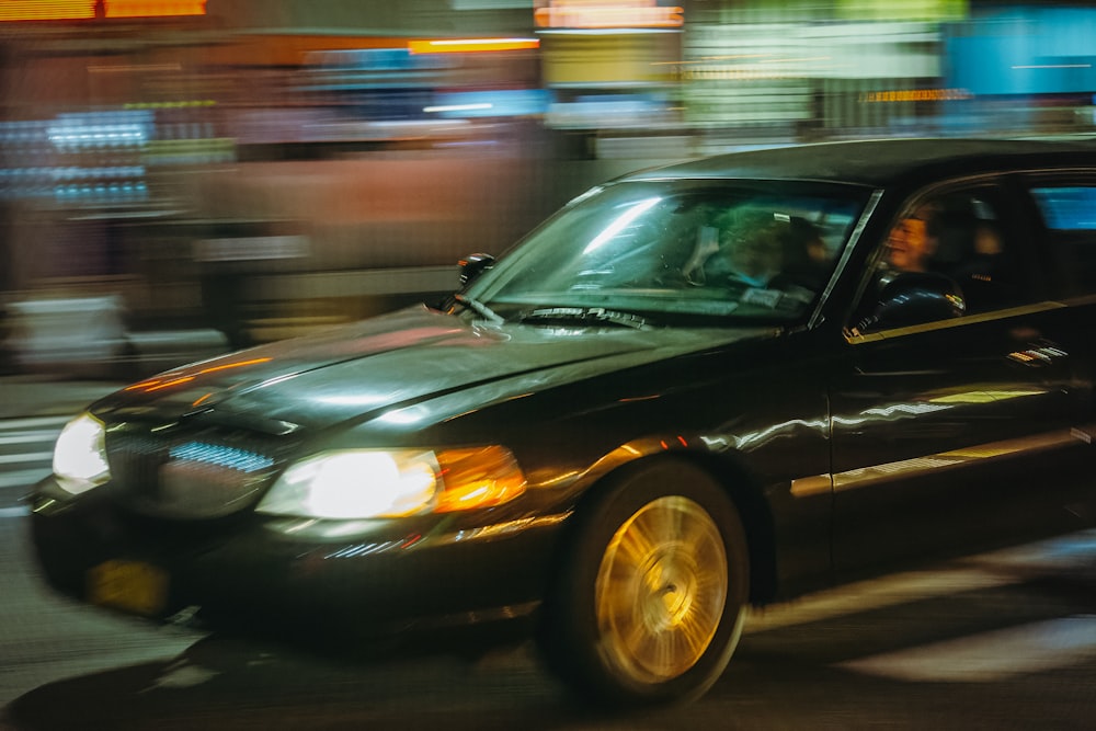 a black car with people in it