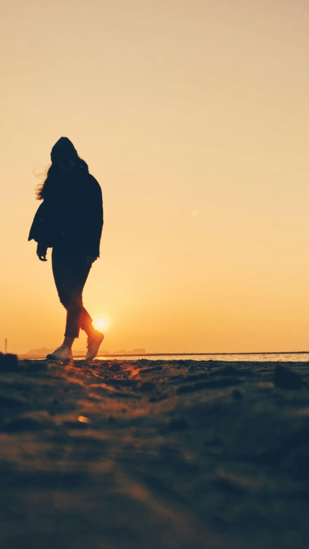 a person walking on a beach