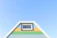 A freshly painted house facade with vibrant siloxane paint under a clear blue sky.