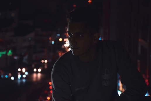 A weary person sitting amidst a bustling cityscape with muted colors reflecting stress.