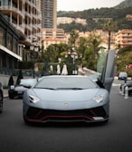 a white sports car parked on the side of a street