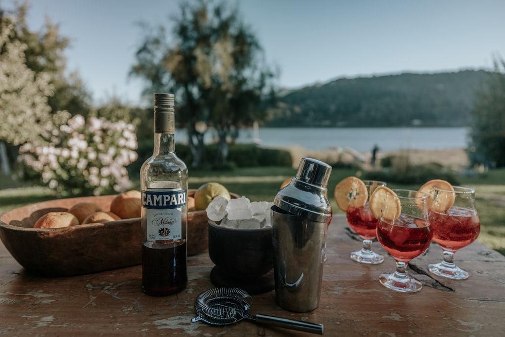 a table with glasses of wine and a bottle of wine