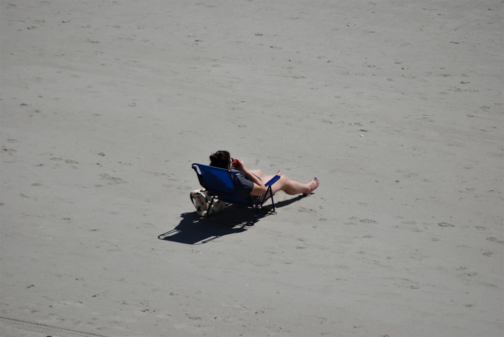 a man lying in a chair on the beach