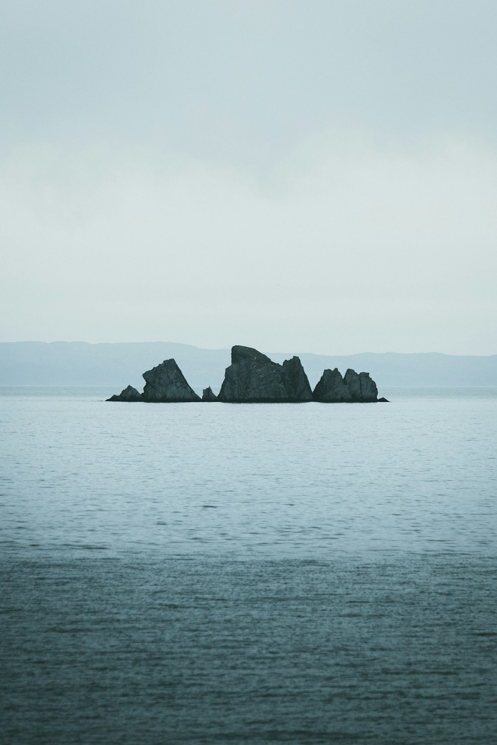 a group of large rocks in the water