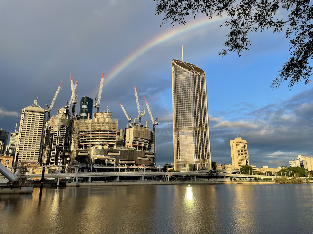 a city skyline with a rainbow