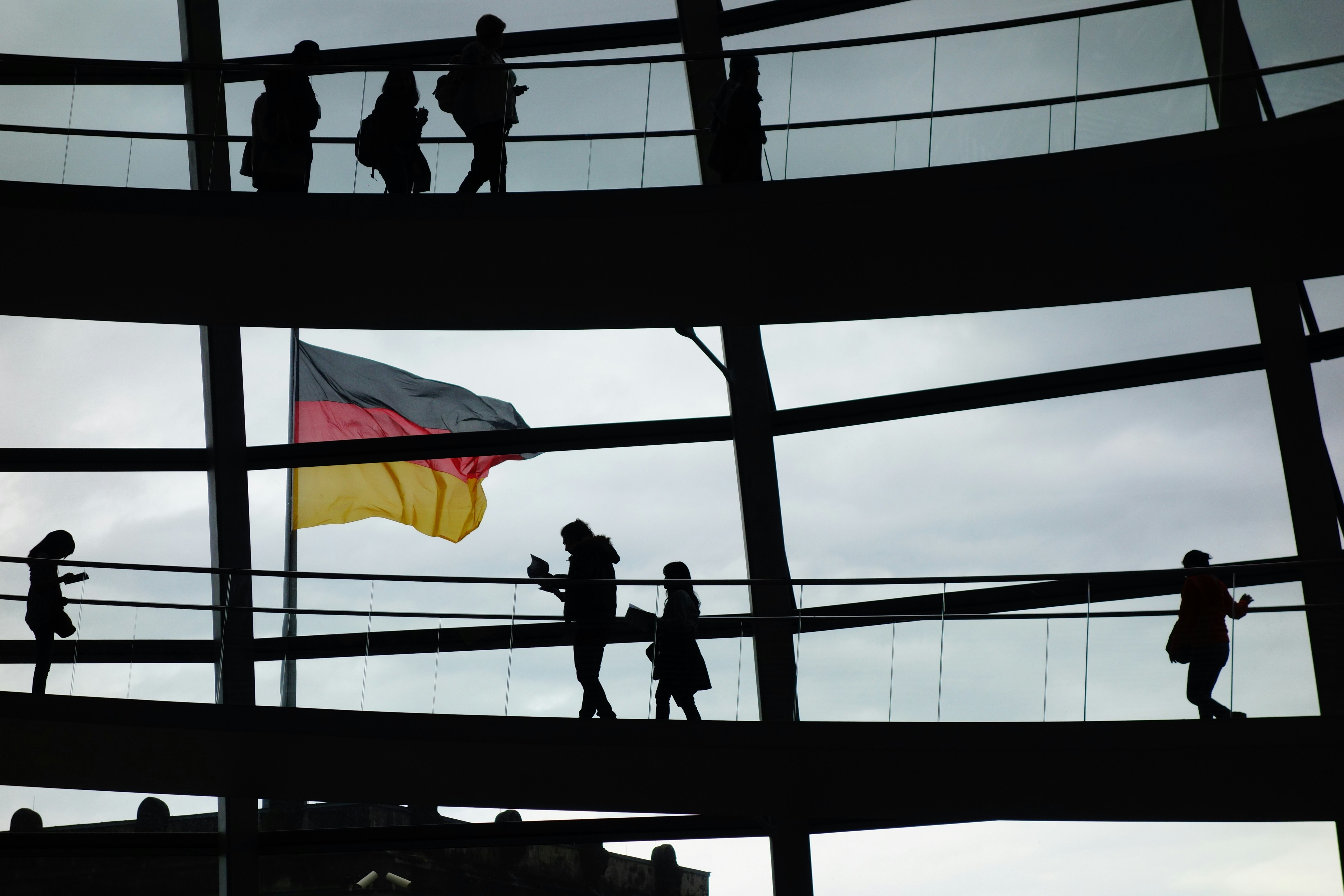 a group of people standing on a bridge holding a flag