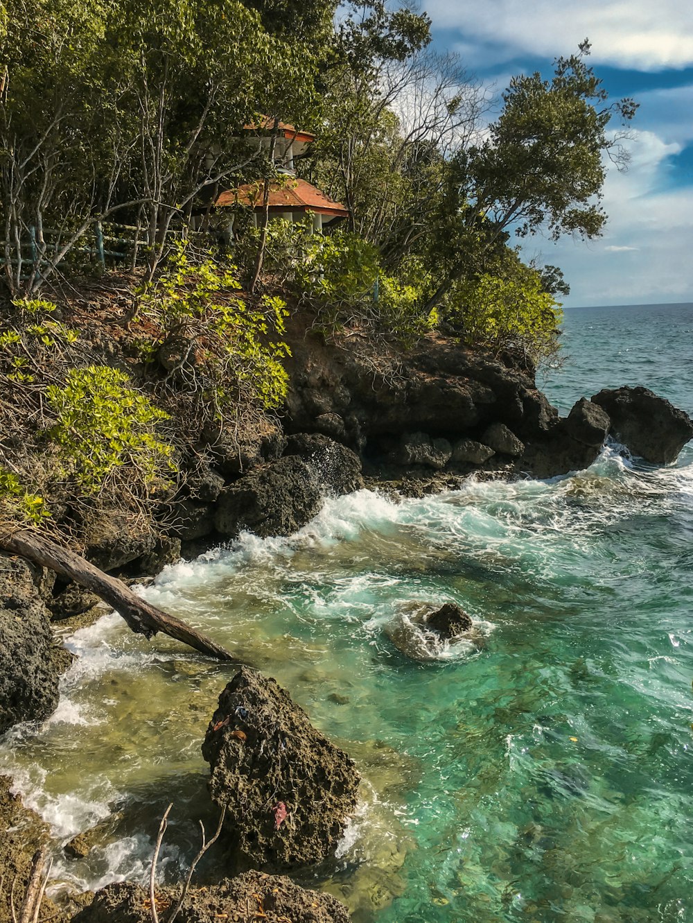 a rocky beach with a pagoda