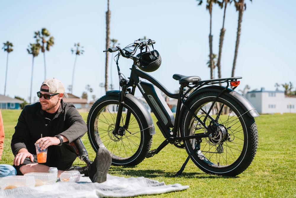 a person sitting next to a bicycle