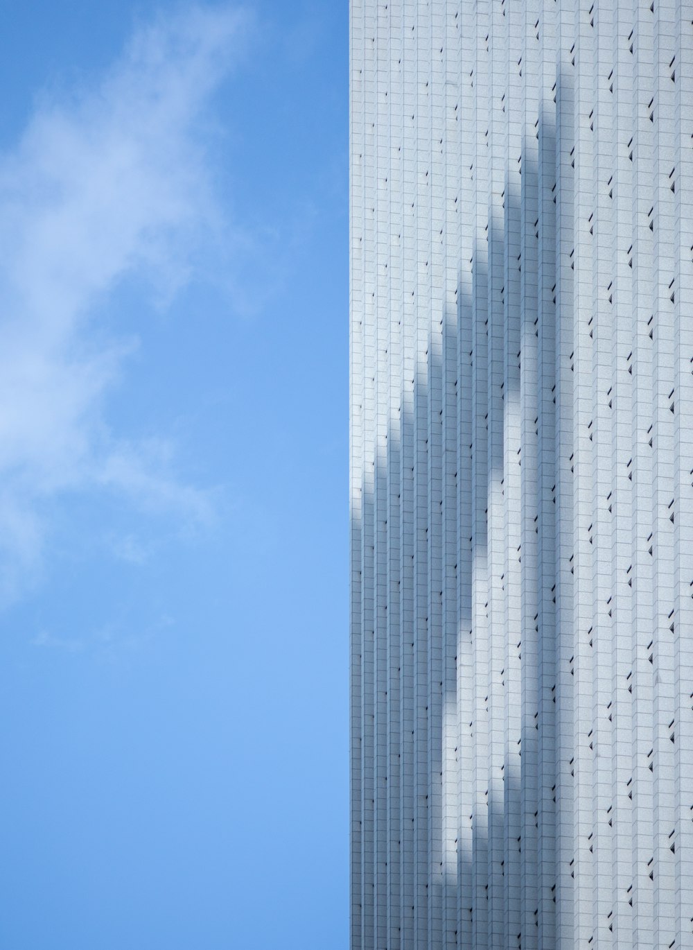 a tall building with a blue sky