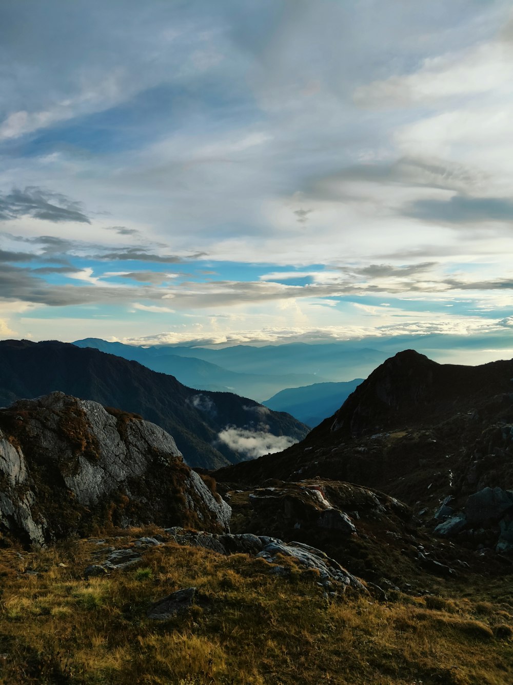 a landscape with mountains and clouds