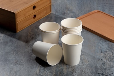 a cup of coffee sitting on top of a wooden table