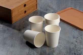 a cup of coffee sitting on top of a wooden table