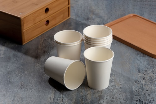 a cup of coffee sitting on top of a wooden table