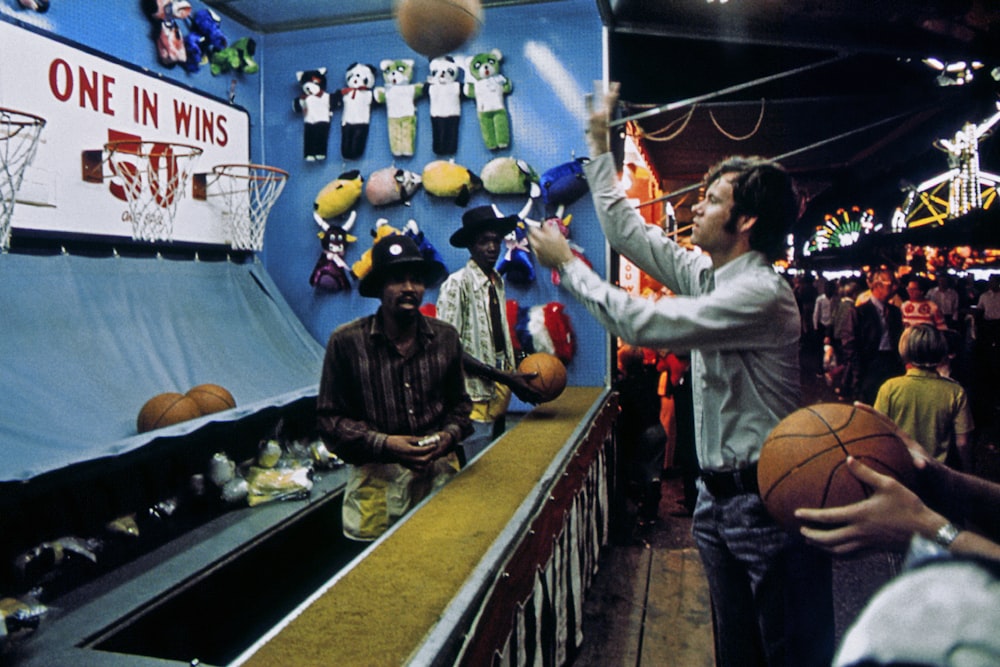 a person serving a basketball to a crowd