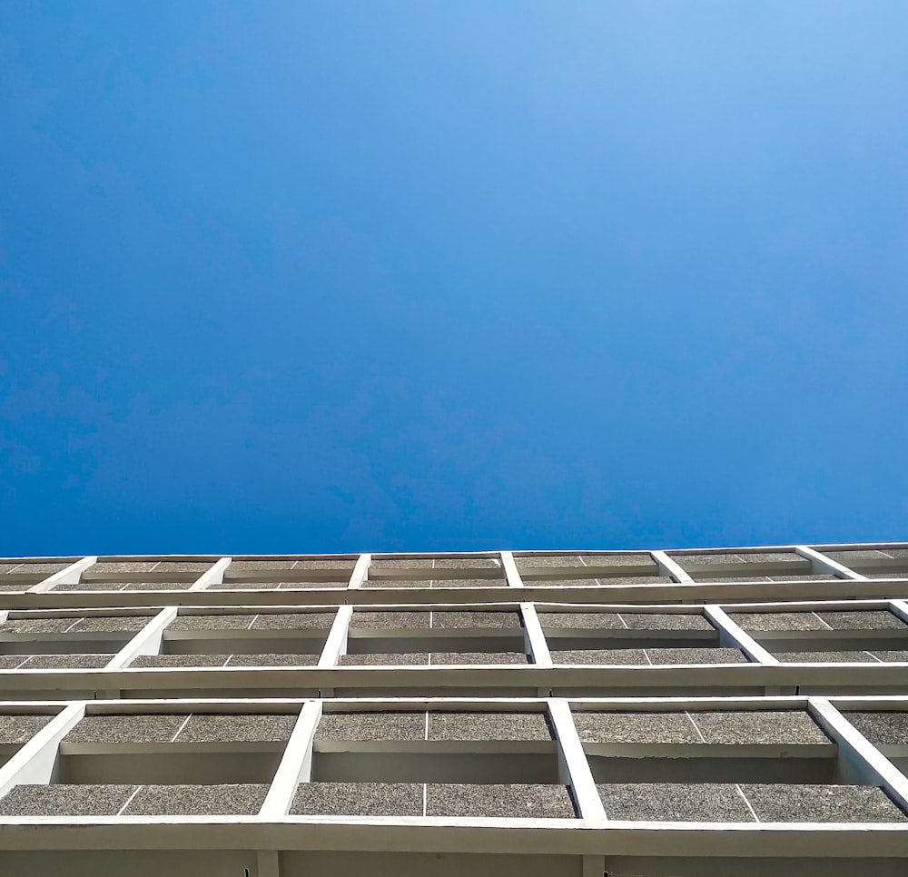 a row of wooden planks with a blue sky in the background