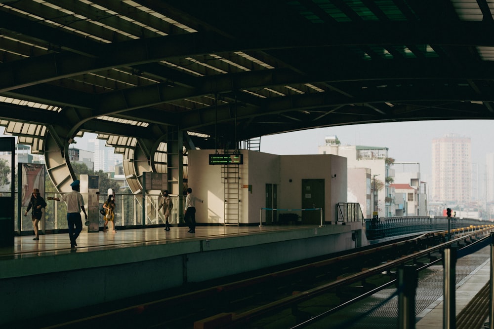 電車のプラットホームを歩く人々のグループ