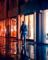 Model wearing a vibrant hoodie walking through a city street at dusk