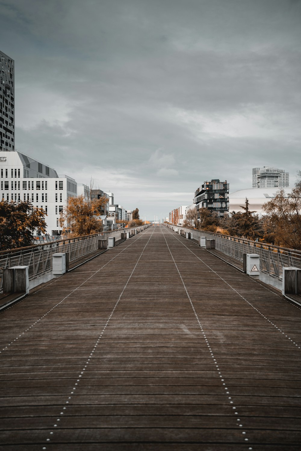 a wooden walkway with buildings in the background