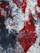 A vibrant abstract painting with swirling textures. The image features a mix of red, black, and white colors, creating a dynamic and intense visual effect. The brush strokes and patterns appear fluid and somewhat chaotic, suggesting movement and emotion.