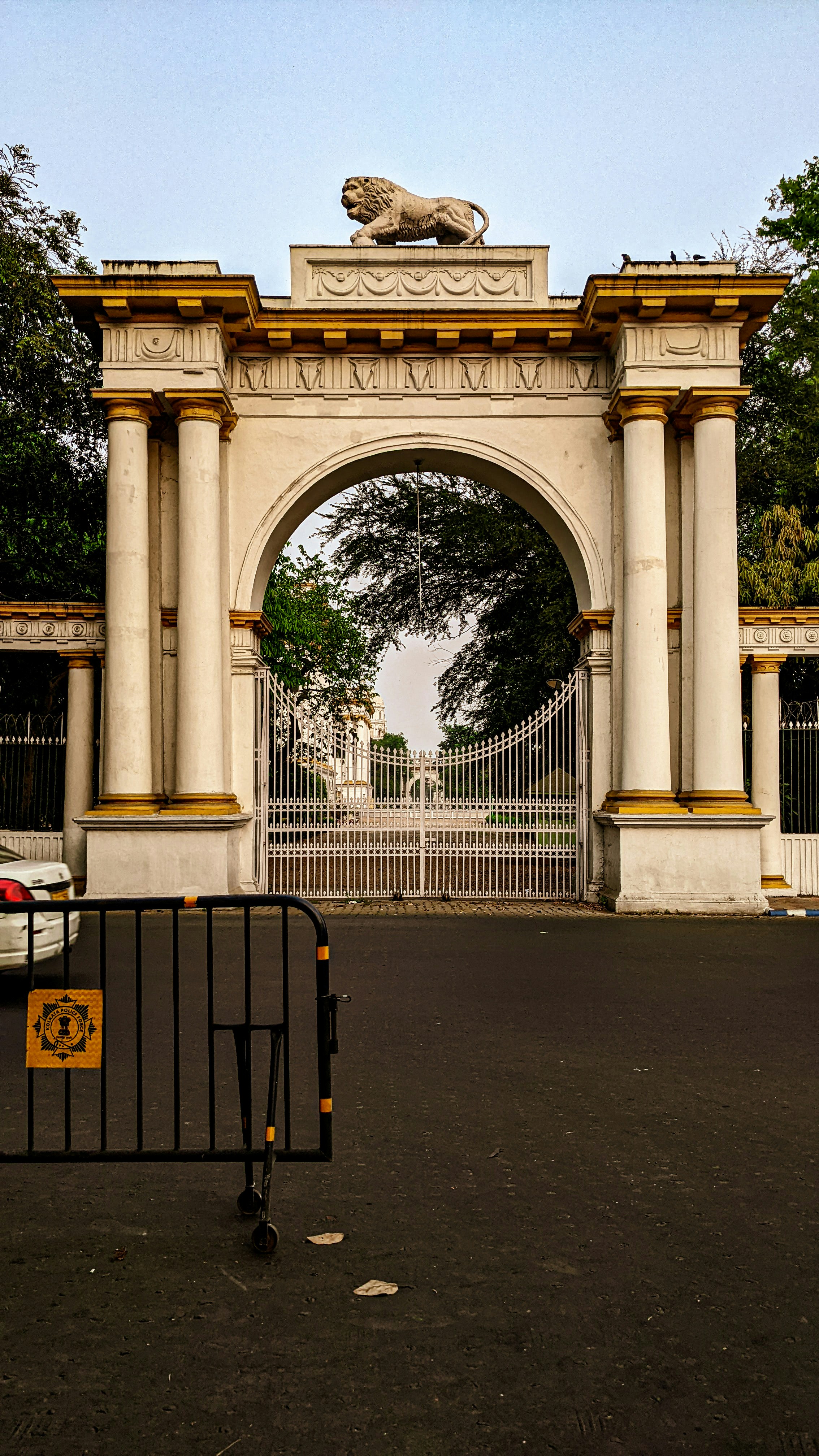 a gate with a statue on top