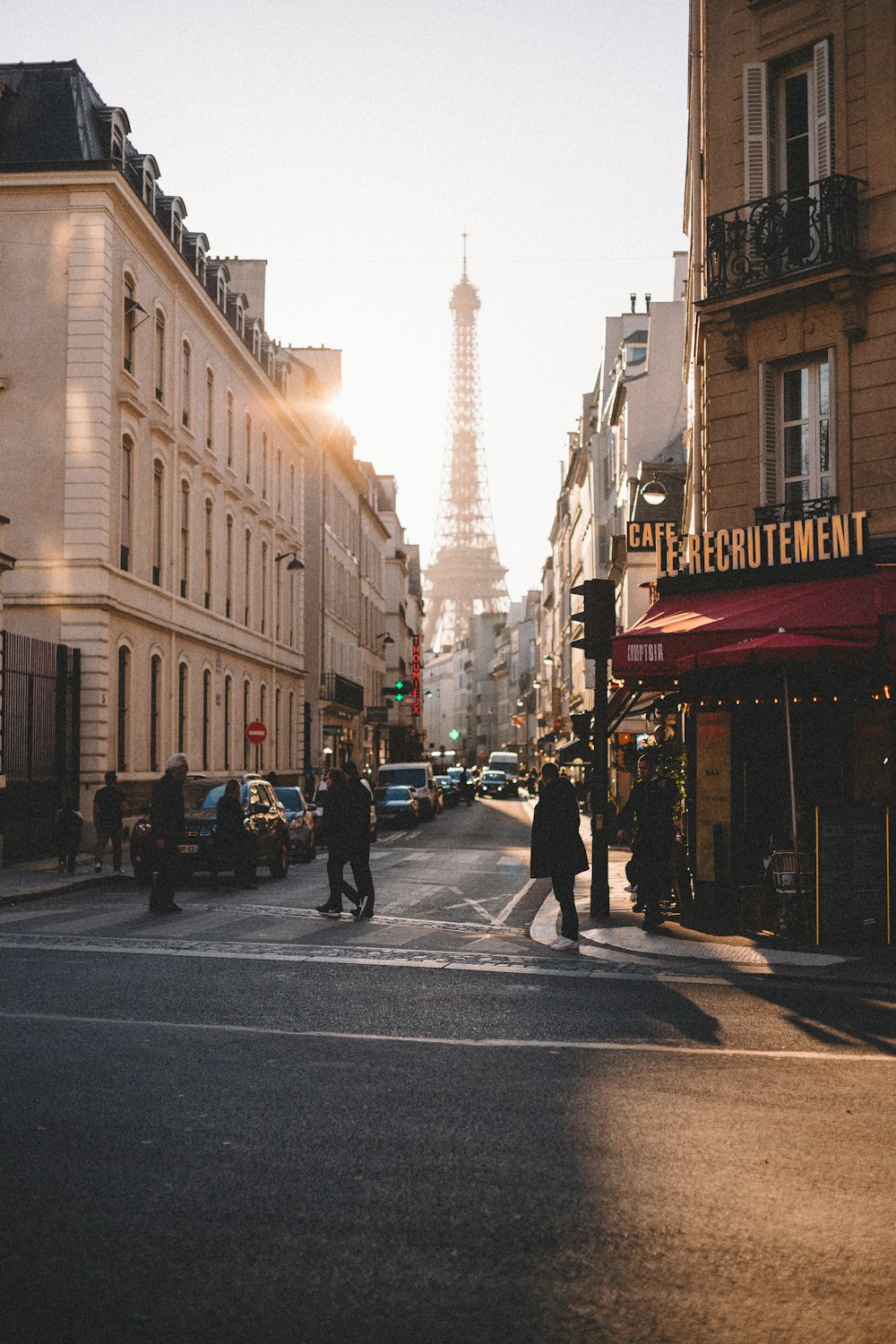 a group of people walking on a city street