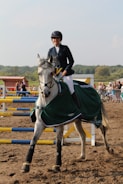Stylish equestrian apparel showcased in a natural setting.