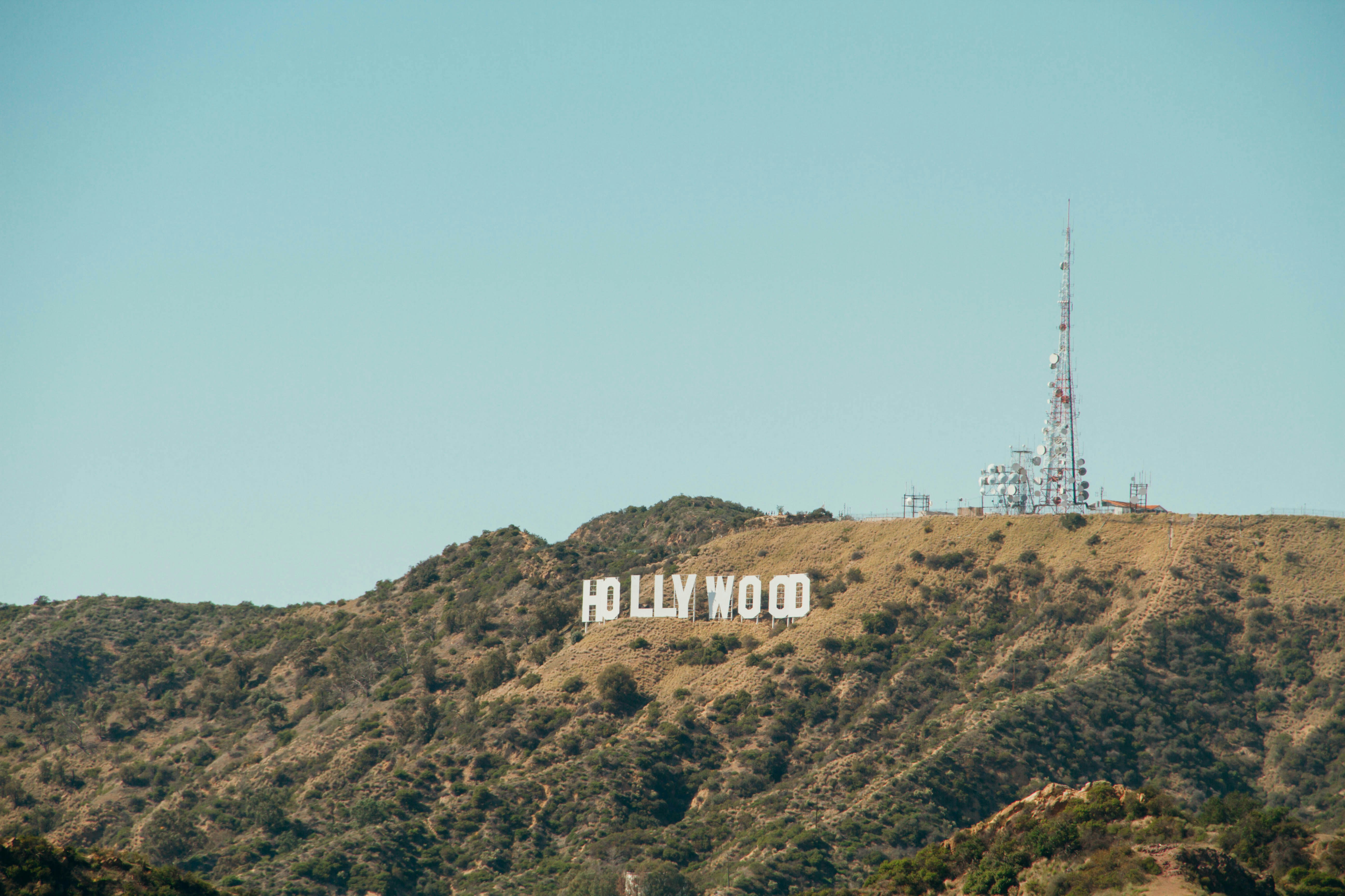 a sign on a hill with Hollywood Sign in the background