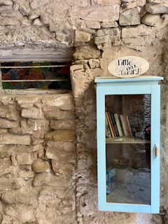 a blue door with a sign above it