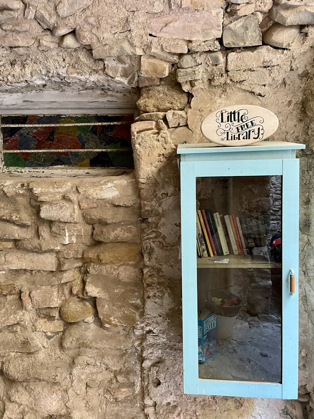 a blue door with a sign above it