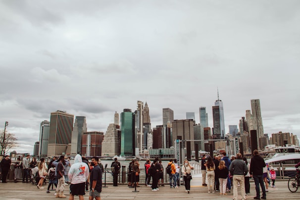 A group of diverse contractors shaking hands in front of a city skyline.
