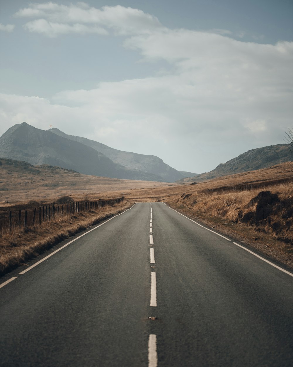 a road with mountains in the background