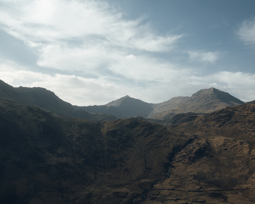 a landscape with hills and clouds