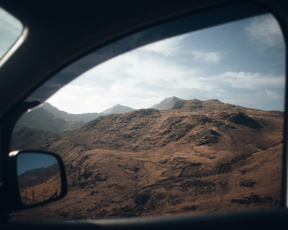 a view of a mountain range from a car window