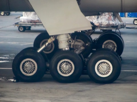 Close-up of aircraft landing gear during maintenance check.