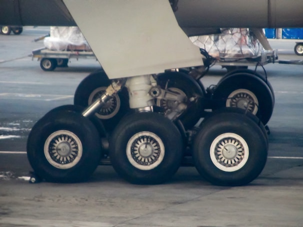 Technician performing safety checks on an aircraft’s landing gear