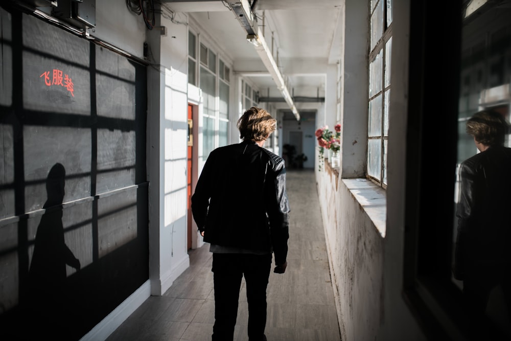 a man walking down a hallway