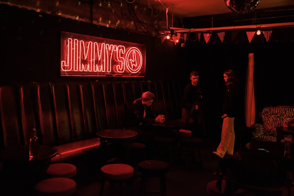 a group of people standing in a bar