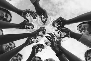 a group of people holding wine glasses