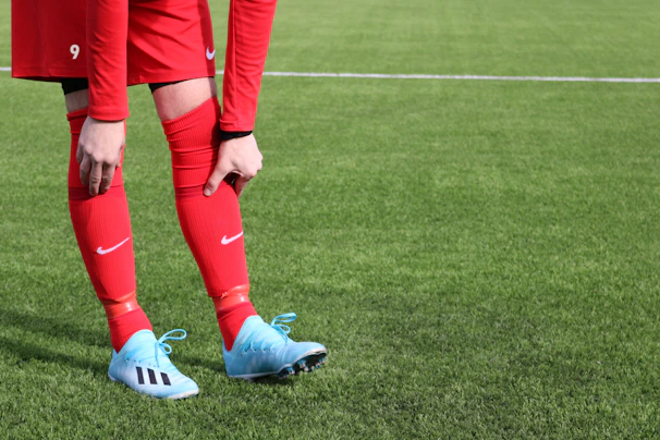 a person in red and blue football uniform on a field