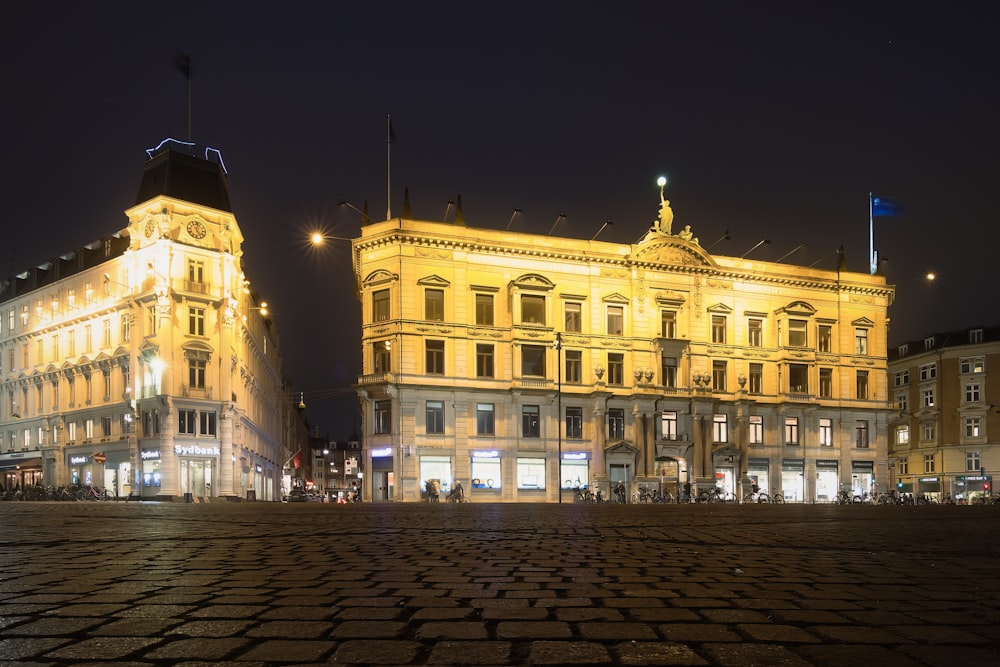 a large building with a flag on top at night