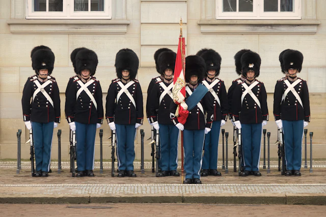 Royal Life Guards in bearskin caps standing in formation outside Amalienborg Palace