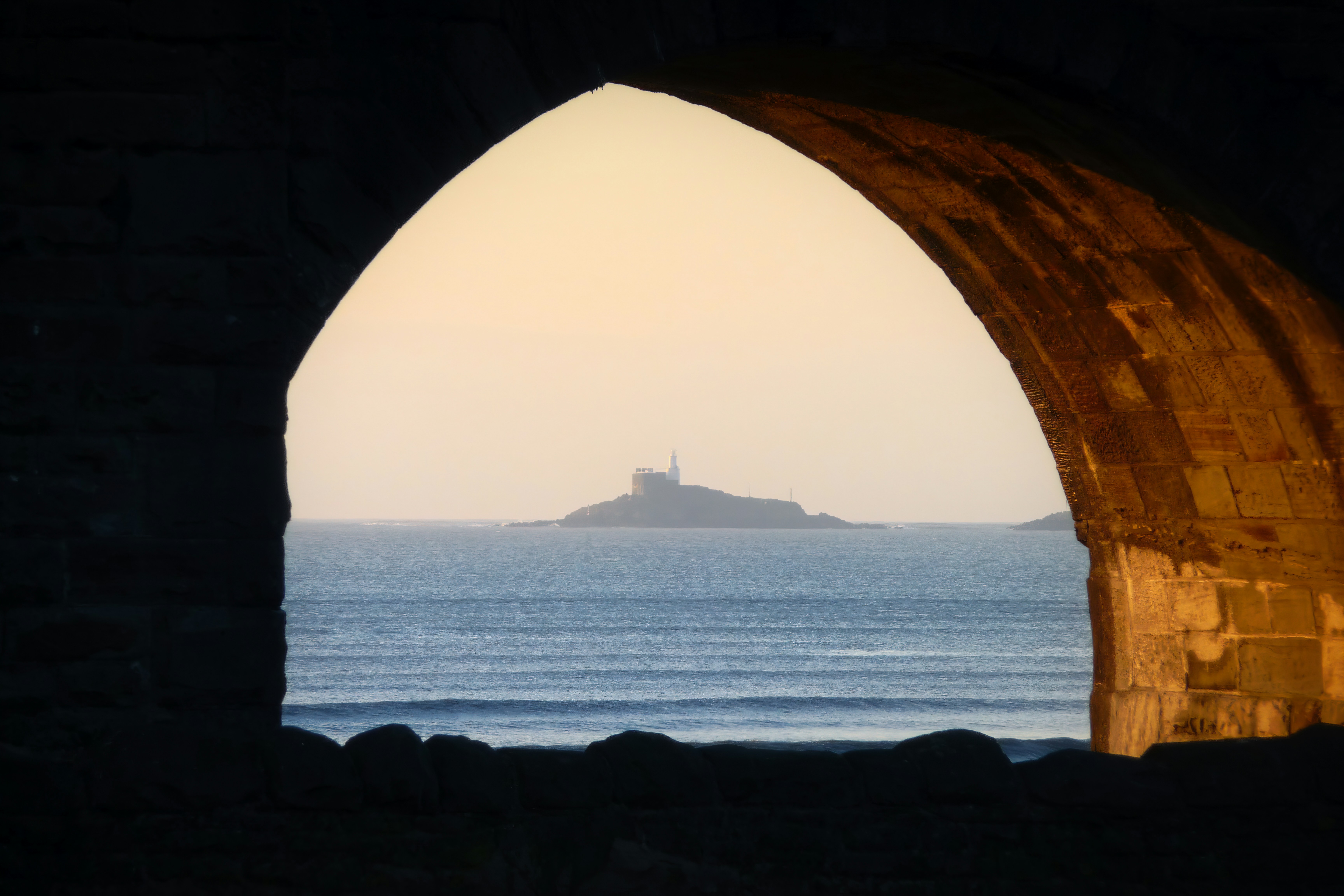 Mumbles lighthouse at sunrise, seen from Oystermouth Road in Swansea