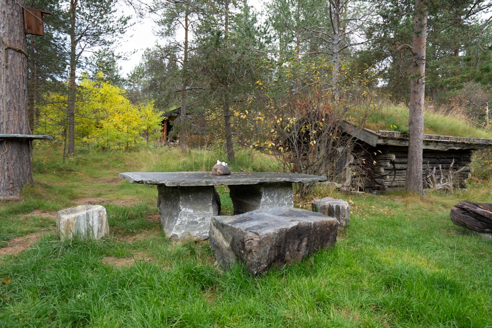 a stone bench in a park