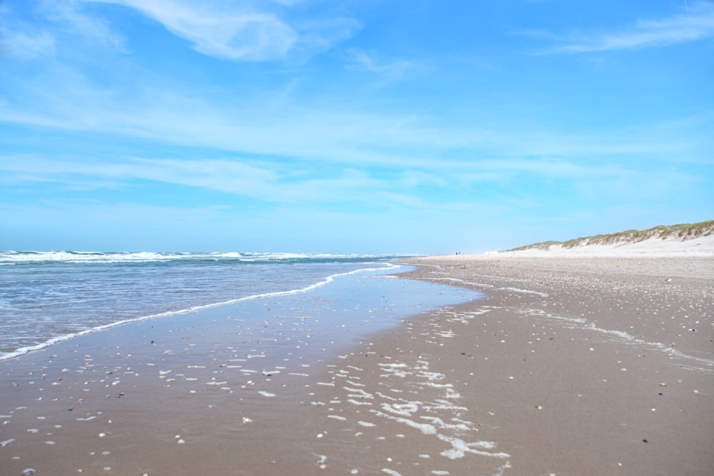 a beach with waves crashing on it