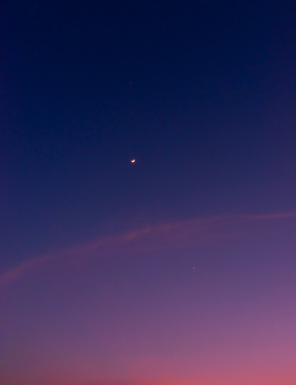 a blue sky with a pink and purple cloud