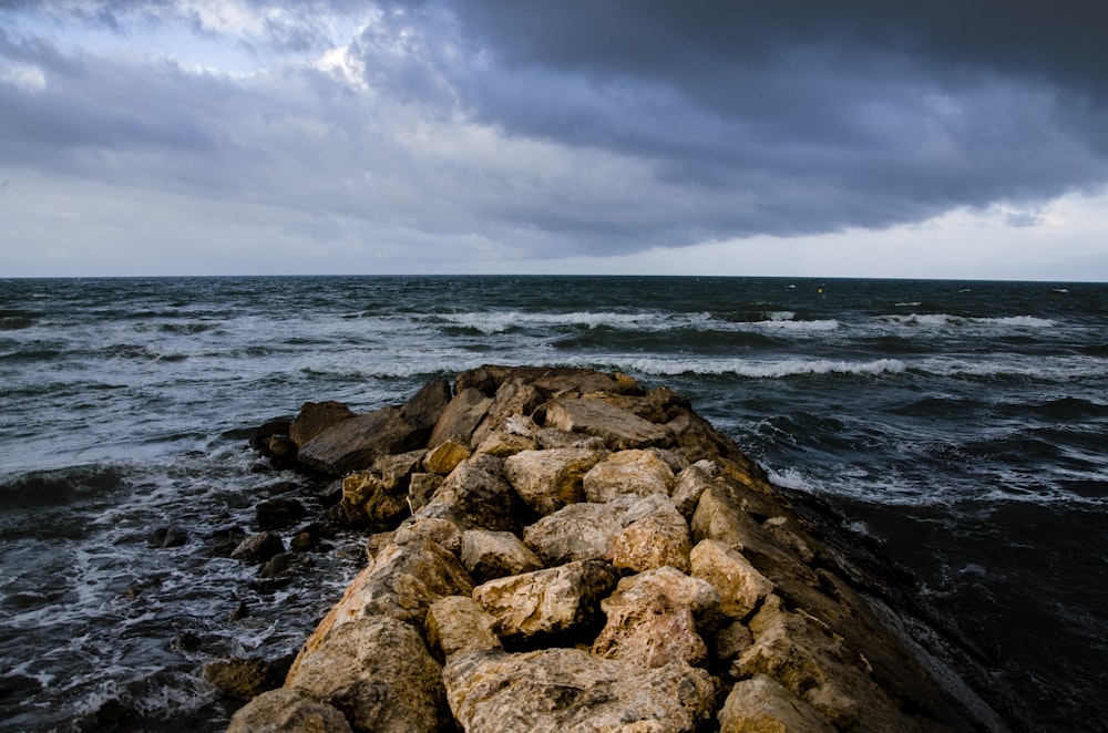 a rocky beach with waves crashing