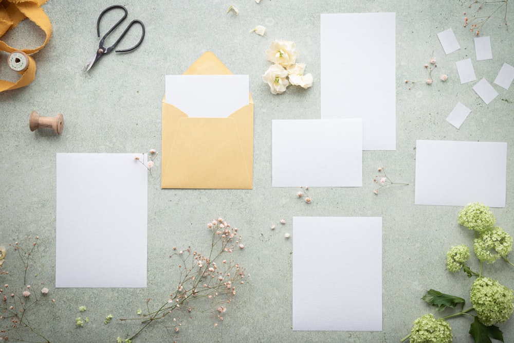a group of white paper squares on a grey surface